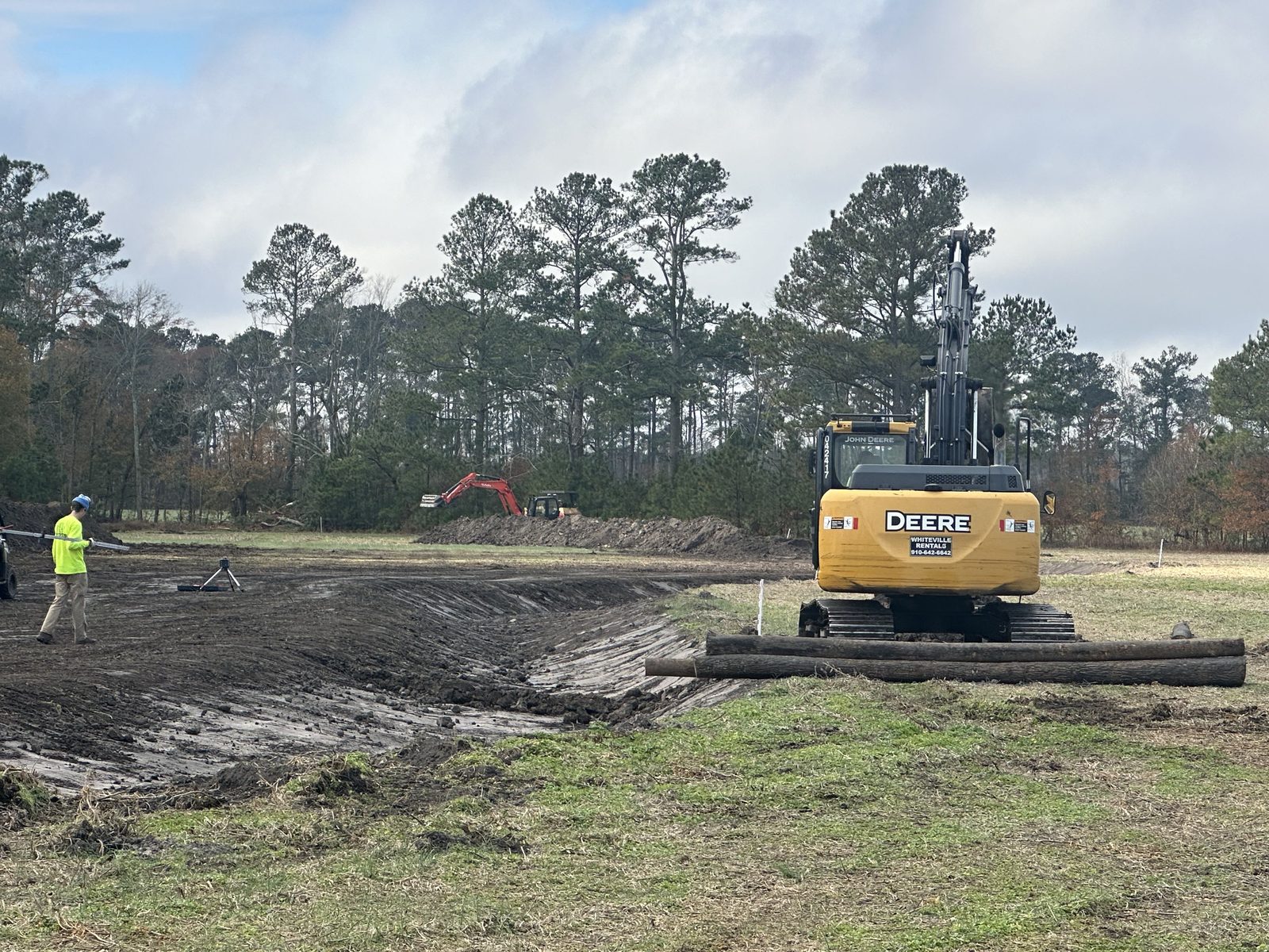 John Deere excavator digging on a job site