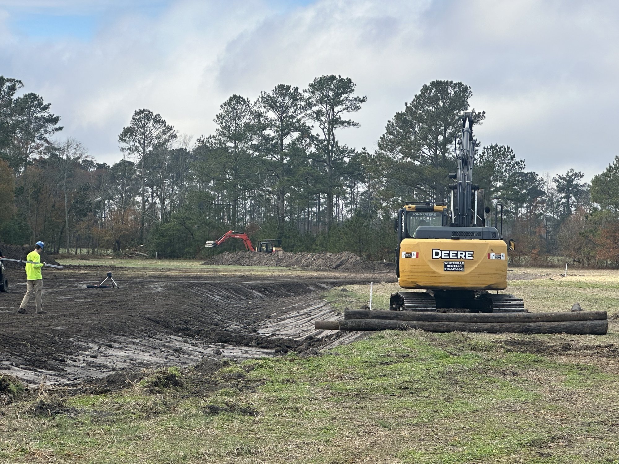 Excavators staged across a channel restoration work area