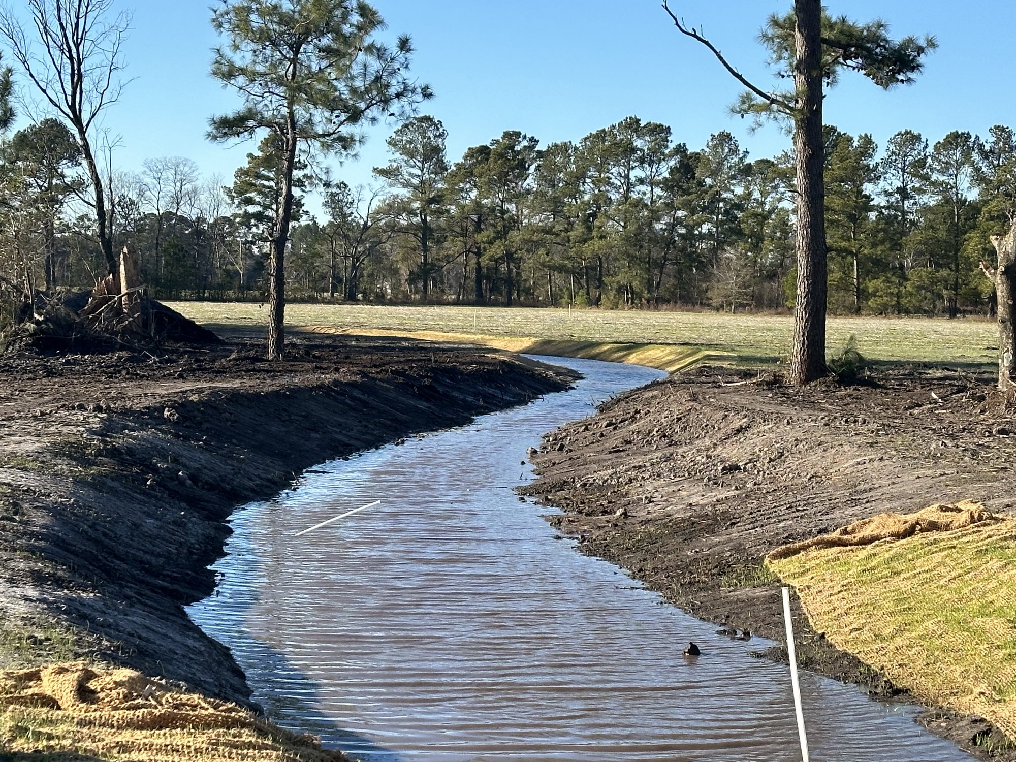 Newly shaped stream bend with stabilized banks and flowing water