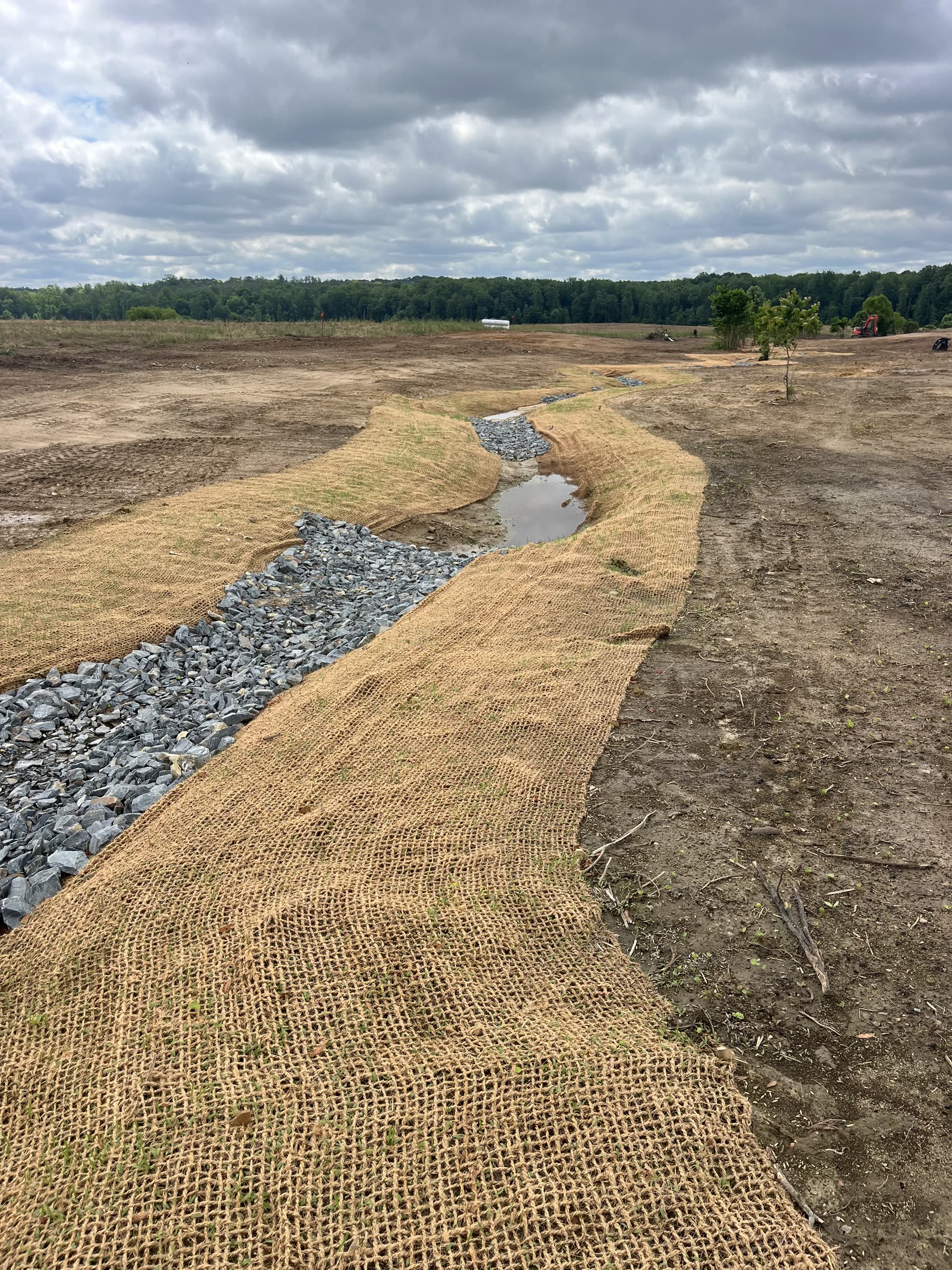 Reclaimed ground shaped around a stabilized drainage channel